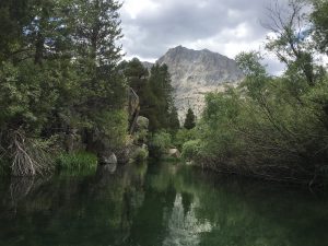 rush creek photo taken from kayak with water in foreground and mountains in background